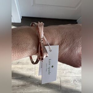 Kate Spade rose colored bow bangle.